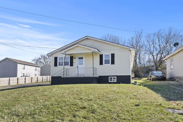 bungalow-style house featuring fence and a front yard