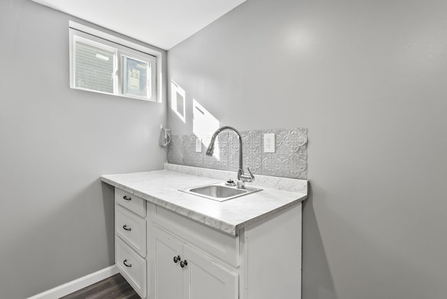 bathroom featuring vanity, baseboards, and wood finished floors