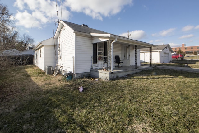 exterior space with central air condition unit, covered porch, and a lawn