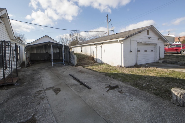 detached garage featuring a detached carport