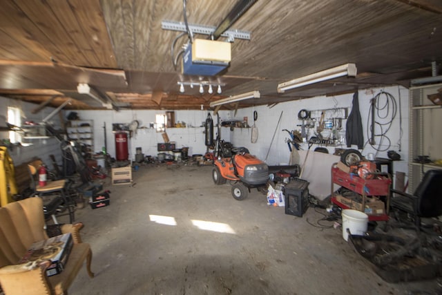 garage with a workshop area and a garage door opener