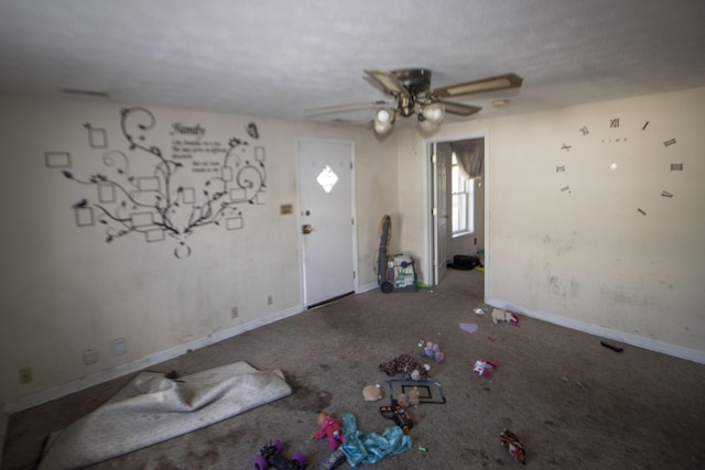 interior space featuring ceiling fan and baseboards