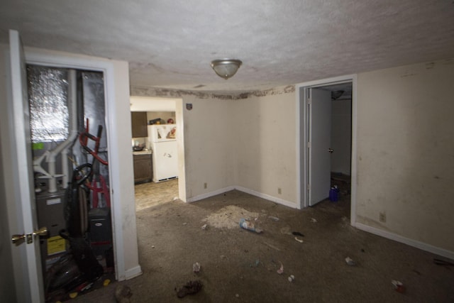 unfurnished room with baseboards and a textured ceiling