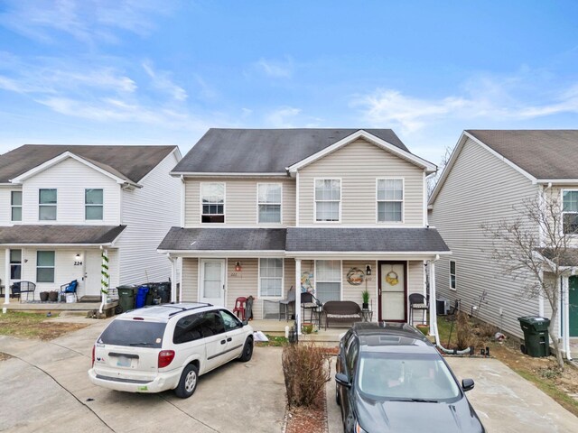 view of front of home with a shingled roof and a porch