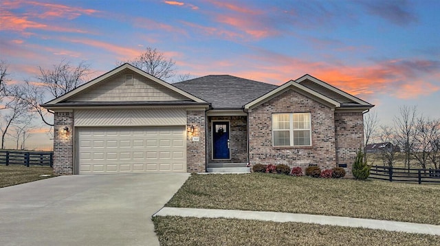 single story home with driveway, an attached garage, fence, and brick siding