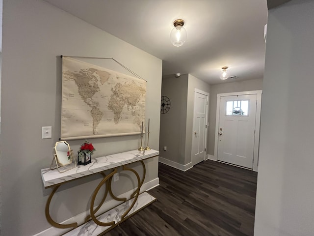 entryway with baseboards and dark wood-style flooring