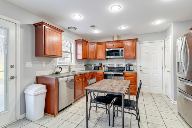 kitchen featuring visible vents, appliances with stainless steel finishes, light tile patterned flooring, a sink, and recessed lighting