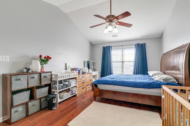 bedroom featuring lofted ceiling, visible vents, wood finished floors, and a ceiling fan