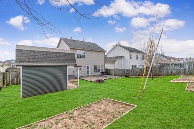 back of house with a patio area, a fenced backyard, a vegetable garden, and a yard