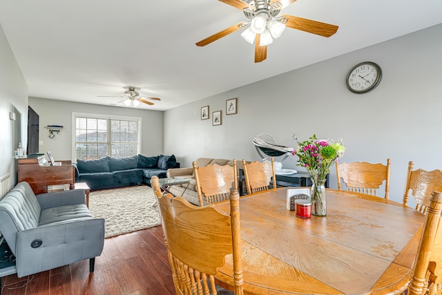 dining space with ceiling fan and wood finished floors