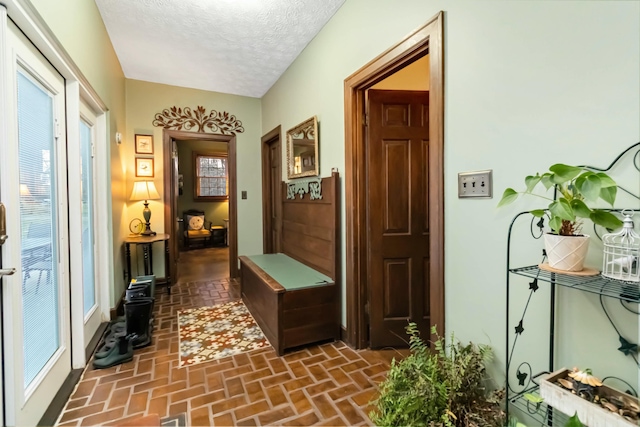 interior space with brick floor and a textured ceiling