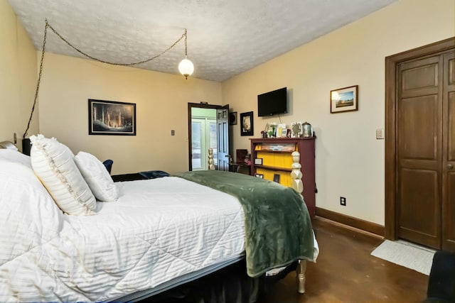 bedroom featuring concrete floors and baseboards