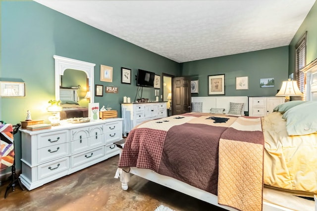 bedroom featuring concrete flooring and a textured ceiling