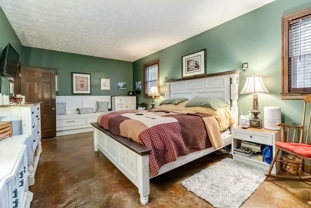 bedroom with a textured ceiling and finished concrete floors