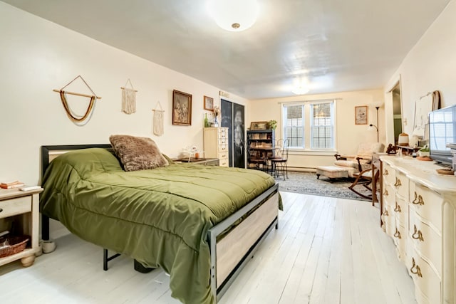 bedroom with light wood finished floors