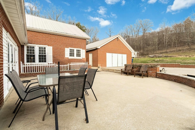 view of patio / terrace featuring an outbuilding and outdoor dining area