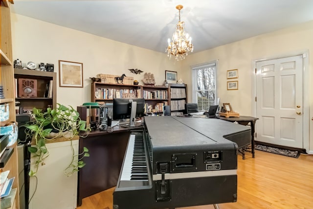 office space with a chandelier and light wood-style flooring