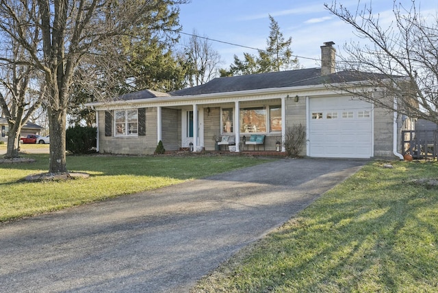 single story home featuring aphalt driveway, an attached garage, covered porch, a front lawn, and a chimney