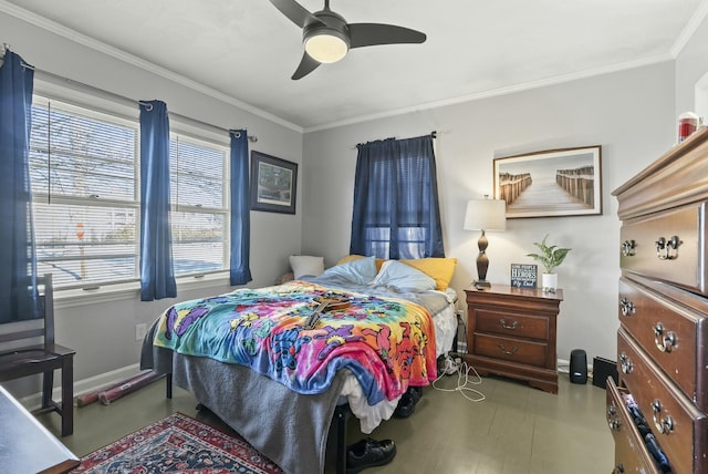 bedroom with a ceiling fan, baseboards, and crown molding