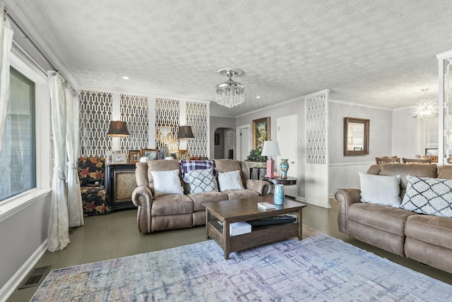 living area with an inviting chandelier, visible vents, ornamental molding, and a textured ceiling