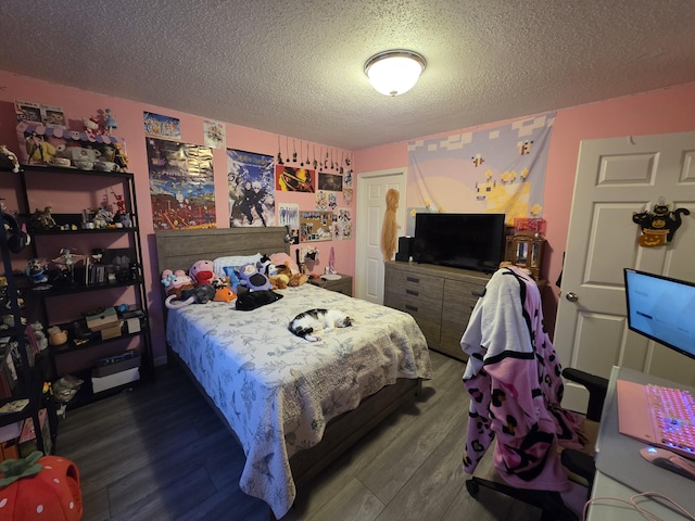 bedroom featuring a textured ceiling and wood finished floors