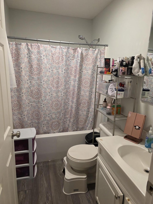 bathroom with vanity, wood finished floors, shower / bath combo with shower curtain, and toilet