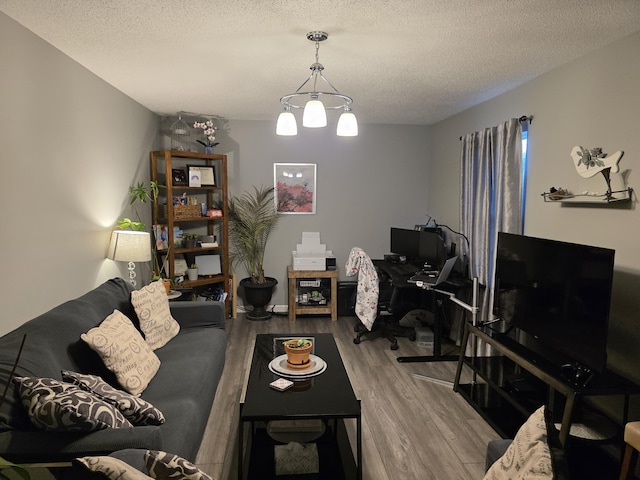 living room with a textured ceiling and wood finished floors