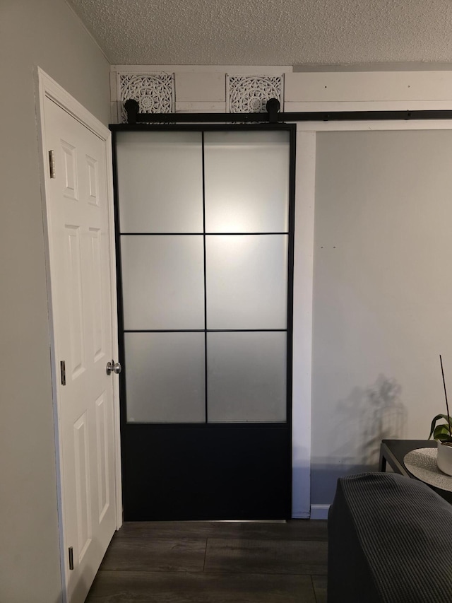 bedroom featuring dark wood-style floors and a textured ceiling