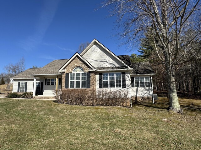 view of front of home with brick siding and a front yard