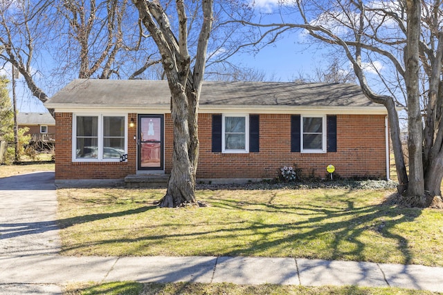 view of front of property with a front yard and brick siding