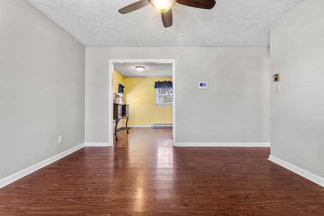 unfurnished room with ceiling fan, baseboards, a textured ceiling, and wood finished floors