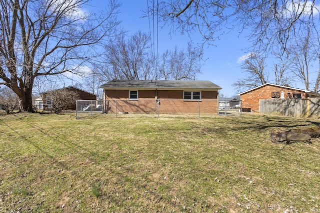 back of house with crawl space, brick siding, a yard, and fence