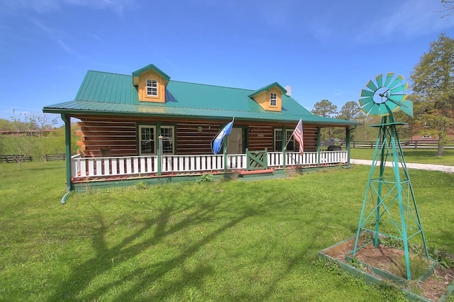 log home featuring metal roof, log exterior, a porch, and a front yard