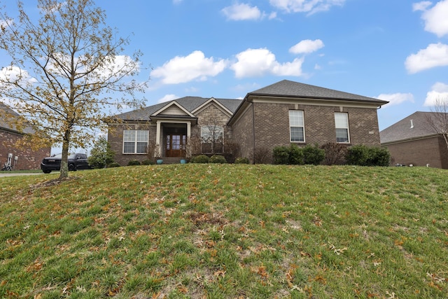 view of front of property with brick siding and a front lawn