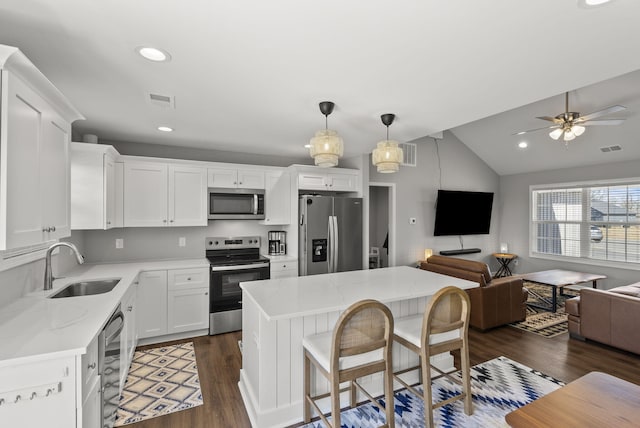 kitchen with visible vents, appliances with stainless steel finishes, dark wood-type flooring, open floor plan, and a sink