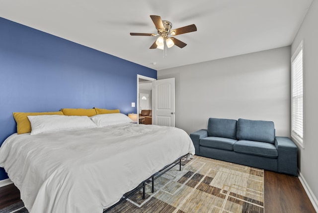 bedroom featuring ceiling fan, wood finished floors, and baseboards