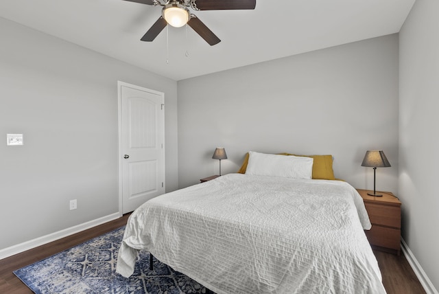 bedroom featuring ceiling fan, baseboards, and wood finished floors