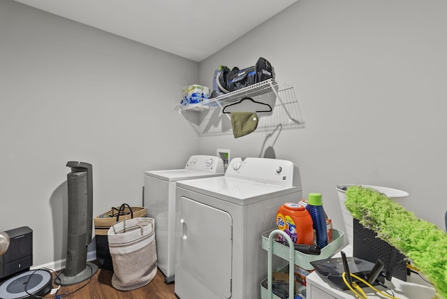 laundry area with laundry area, washer and clothes dryer, wood finished floors, and baseboards