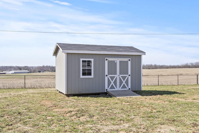 view of shed featuring fence