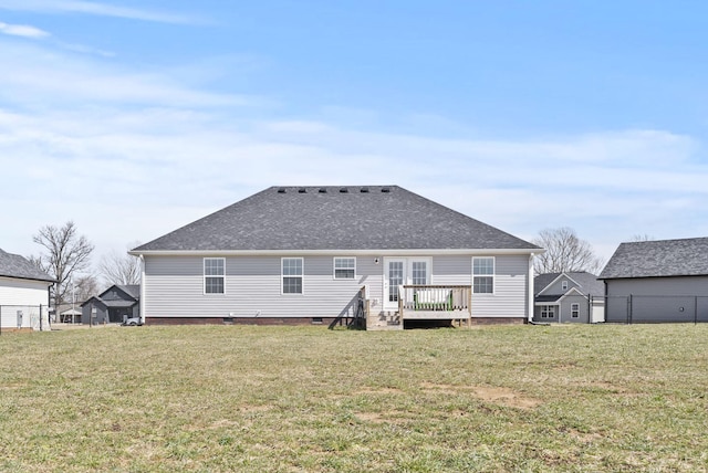 rear view of property with a yard, crawl space, roof with shingles, and a wooden deck