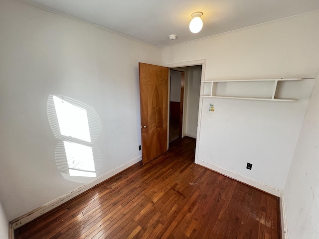 unfurnished bedroom featuring baseboards and hardwood / wood-style floors