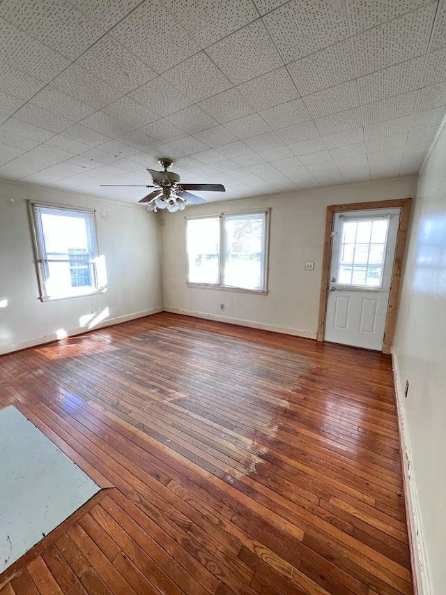 interior space featuring baseboards, plenty of natural light, and hardwood / wood-style floors