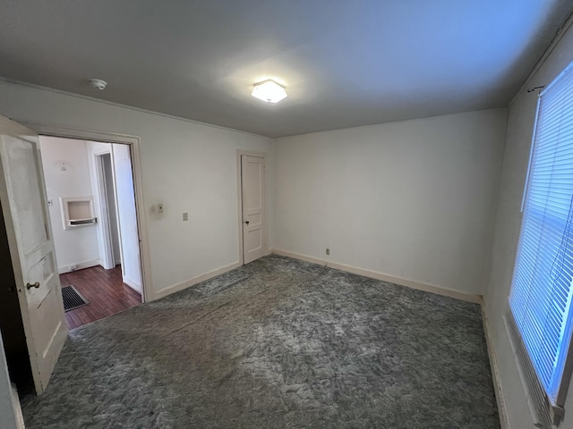 unfurnished bedroom with carpet, visible vents, and baseboards