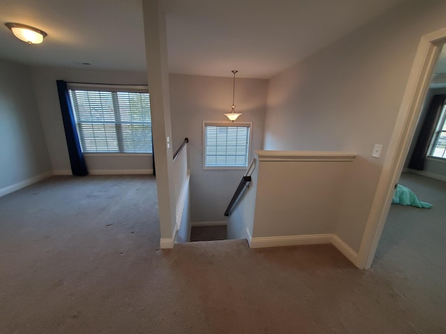 stairway featuring carpet and baseboards