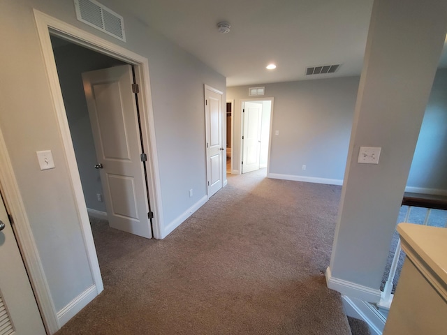 corridor featuring recessed lighting, carpet, visible vents, and baseboards