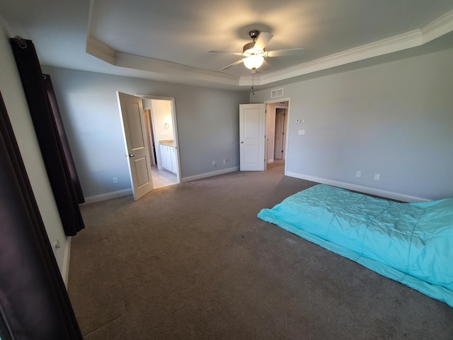 unfurnished bedroom with crown molding, a raised ceiling, visible vents, carpet flooring, and baseboards