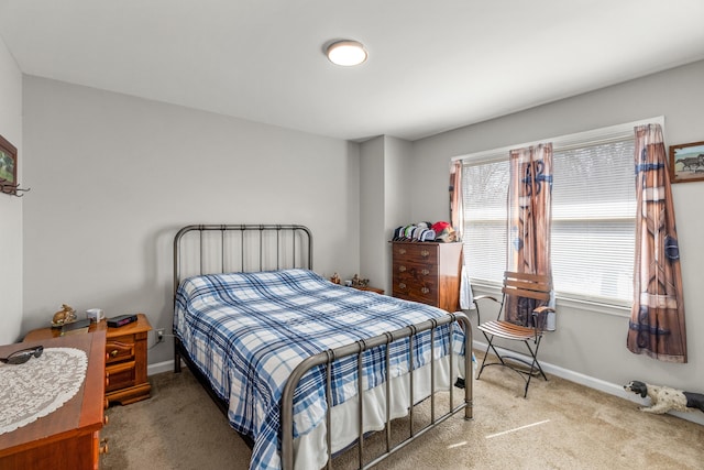 bedroom featuring baseboards and carpet flooring