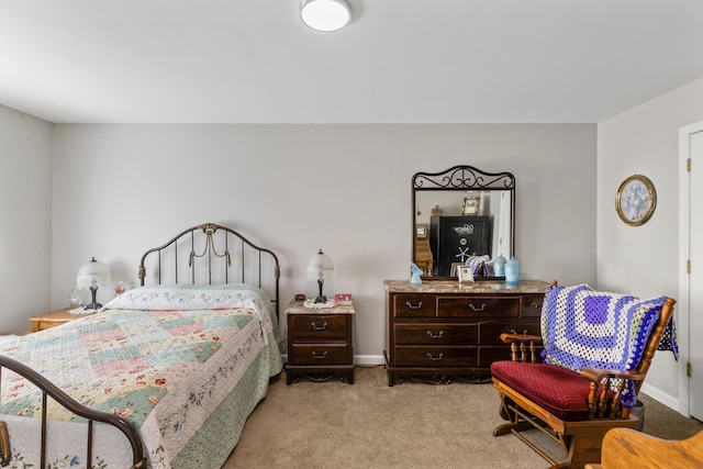 bedroom featuring baseboards and light colored carpet