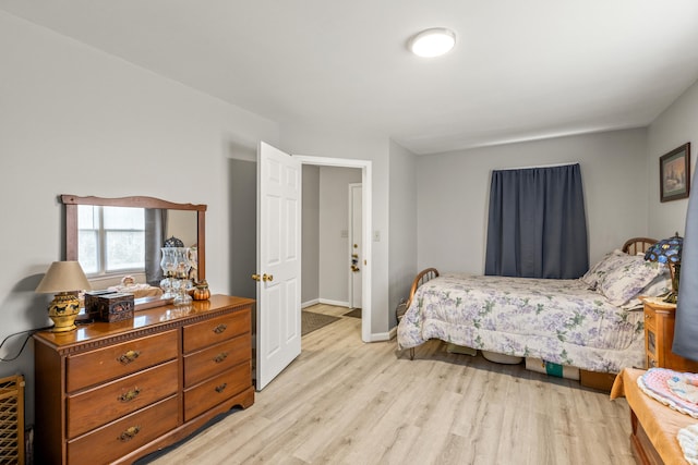 bedroom with light wood-style flooring and baseboards