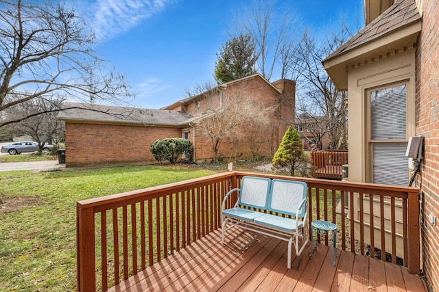 wooden terrace featuring a yard